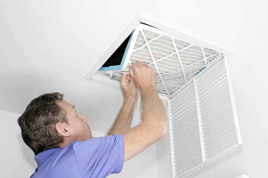 a man is working on a air conditioner for The Chill Brothers.