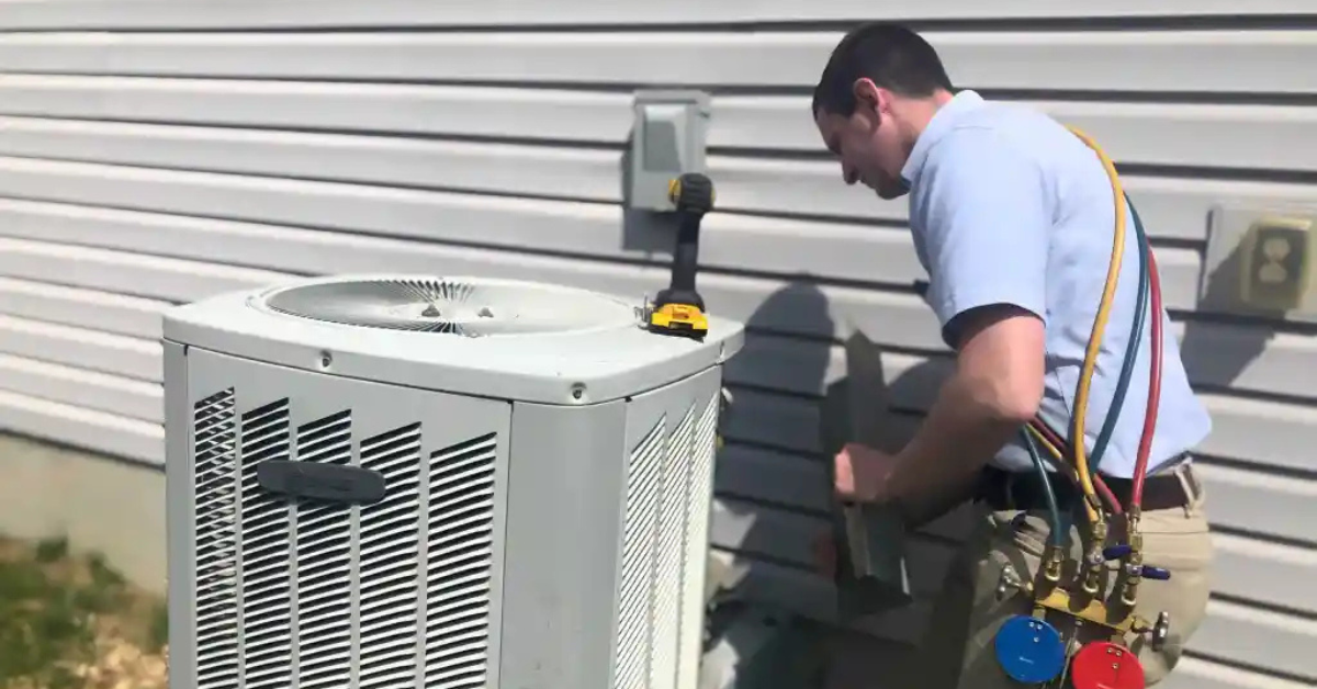 An HVAC technician fixes an air conditioner outdoors in East Austin, TX, highlighting expert heating and cooling services.
