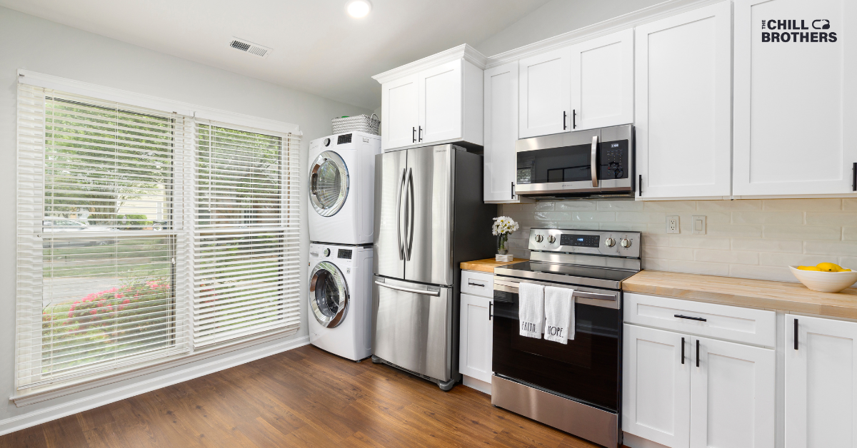 Bright kitchen with large window and stainless steel appliances, highlighting energy use beyond the AC